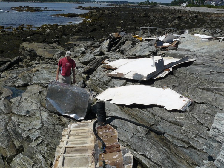 The remains of a motor boat that litter the rocky shore of Peaks Island are expected to be cleaned up this weekend.