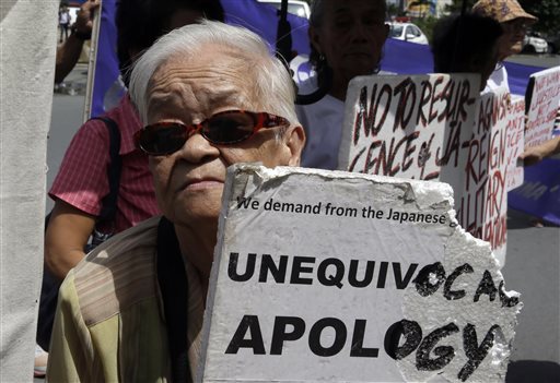 Remedios Tecson, 85, a Filipino "comfort woman" during World War II, displays a placard as she joins a rally outside the Japanese Embassy in Manila ahead of the statement by Japanese Prime Minister Shinzo Abe marking the 70th annivesary of Japan's surrender Friday. The Associated Press