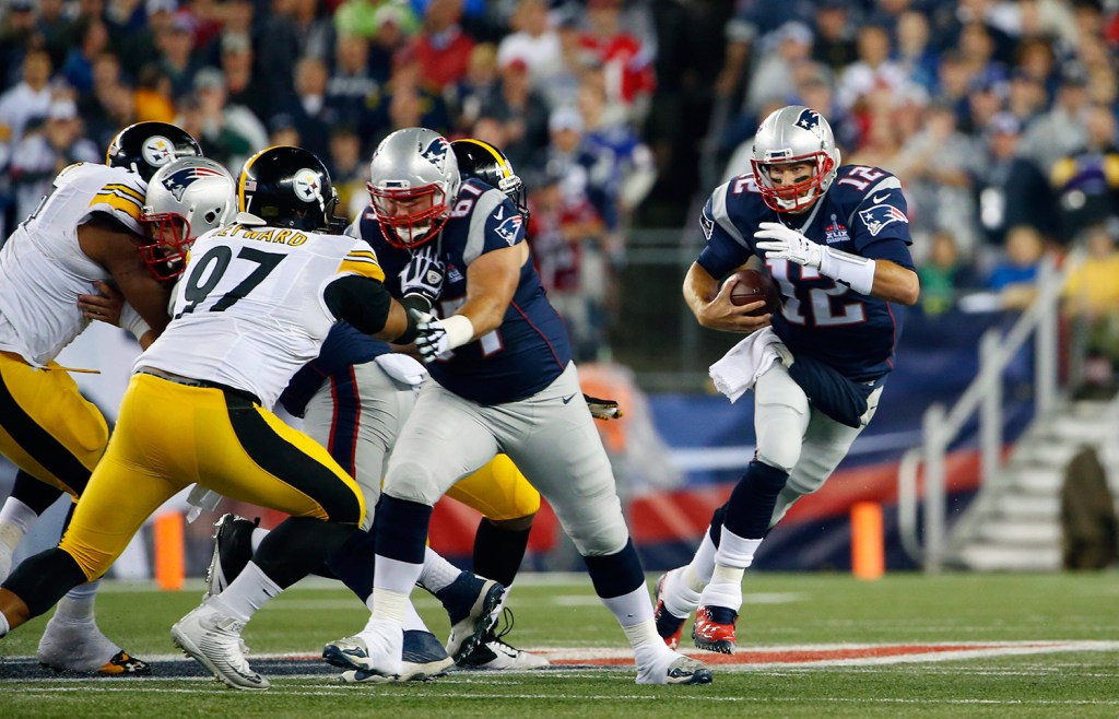 Tom Brady scrambles in the first half against the Steelers' defense. He ended the game with 288 yards and four touchdowns passing.
The Associated Press