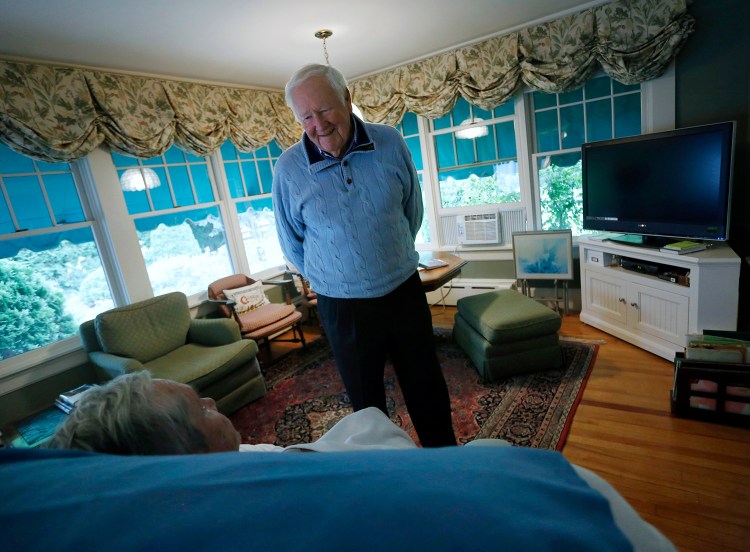 John Marr of Falmouth whose wife Josephine has been battling Alzheimer's for the last seven years recently donated $2 million to Brigham and Women's Hospital in Boston to fund research. John talks to his wife as she rests at their home in Falmouth. Derek Davis/Staff Photographer