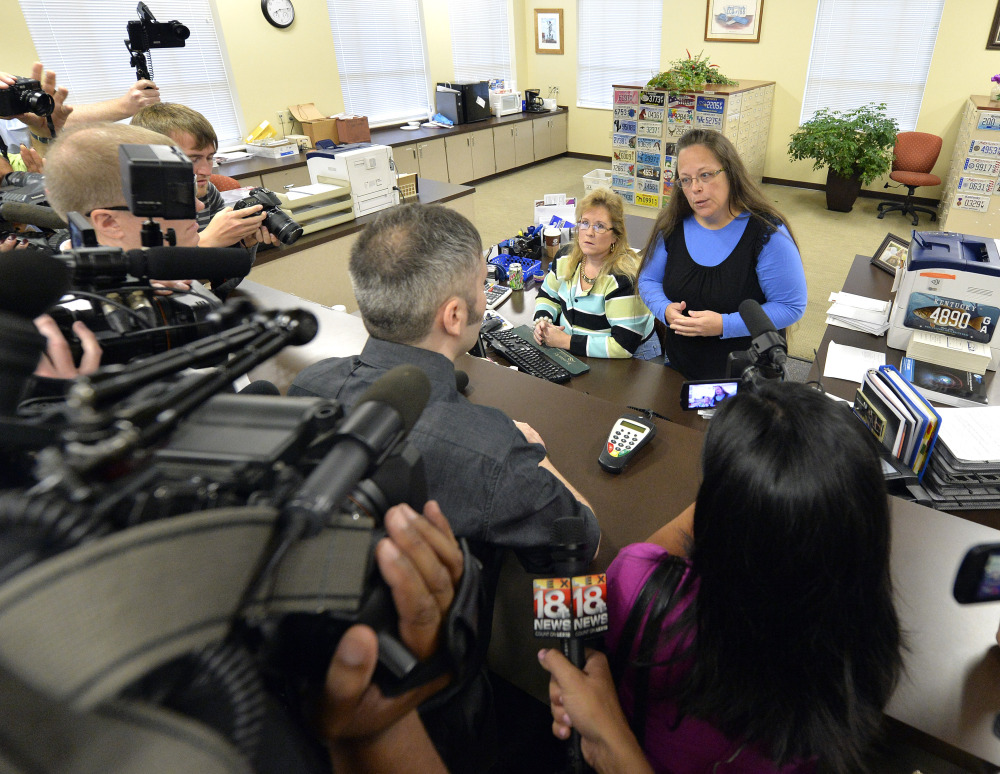 Rowan County Clerk Kim Davis, right, talks with David Moore after her office’s refusal to issue marriage licenses at the Rowan County Courthouse in Morehead, Ky., Tuesday.