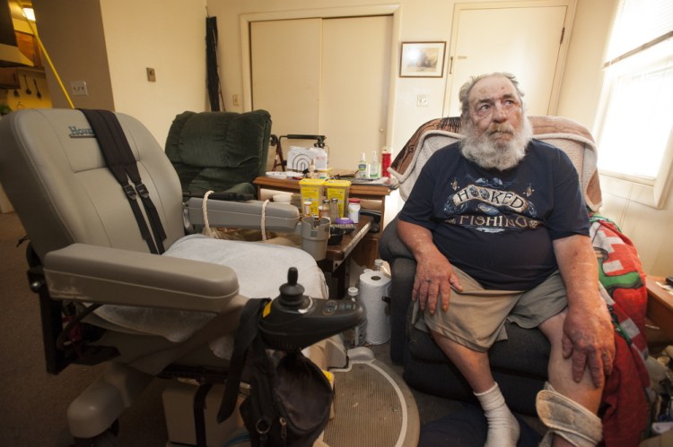 Harvey Lembo sits in an armchair in his living room in Rockland, next to his wheelchair, on Tuesday. Lembo allegedy shot Christopher Wildhaber after Wildhaber broke in and told Lembo he was there to rob him.