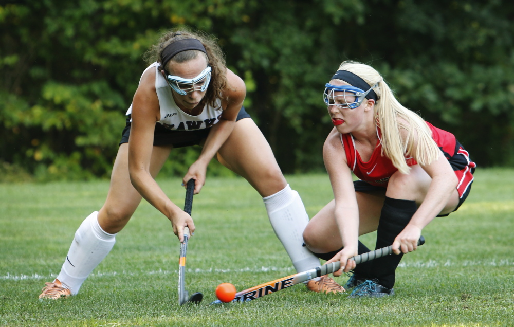 Alexis Tworkowski, left, of Marshwood and Lucy Malia of Scarborough battle for possession during a season-opening field hockey game Wednesday in South Berwick. Scarborough, the reigning Class A state champion, got two second-half goals for a 2-0 victory.