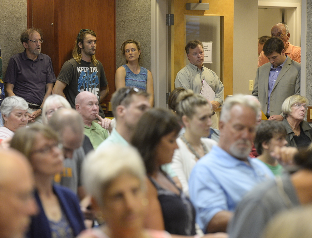 More than 100 people crowded Scarborough’s Town Hall on Wednesday night to hear debate on Higgins Beach access. The council voted 5-2 on the first reading of an ordinance to limit parking.