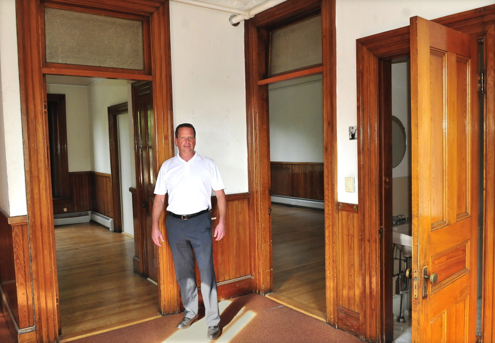 Bill Mitchell stands on the second floor of the Masonic Building on Common Street in Waterville, which he recently bought and plans to renovate and lease.