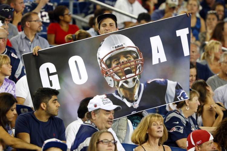 Fans hold a photo of Tom Brady in the stands at Gillette Stadium, celebrating a judge’s reversal of Brady’s four-game suspension earlier Thursday.