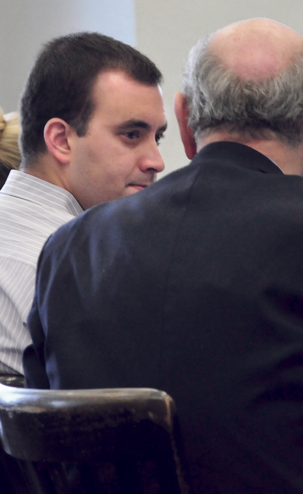 Andrew Maderios speaks with attorney Leonard Sharon on Monday during Maderios’ jury trial.