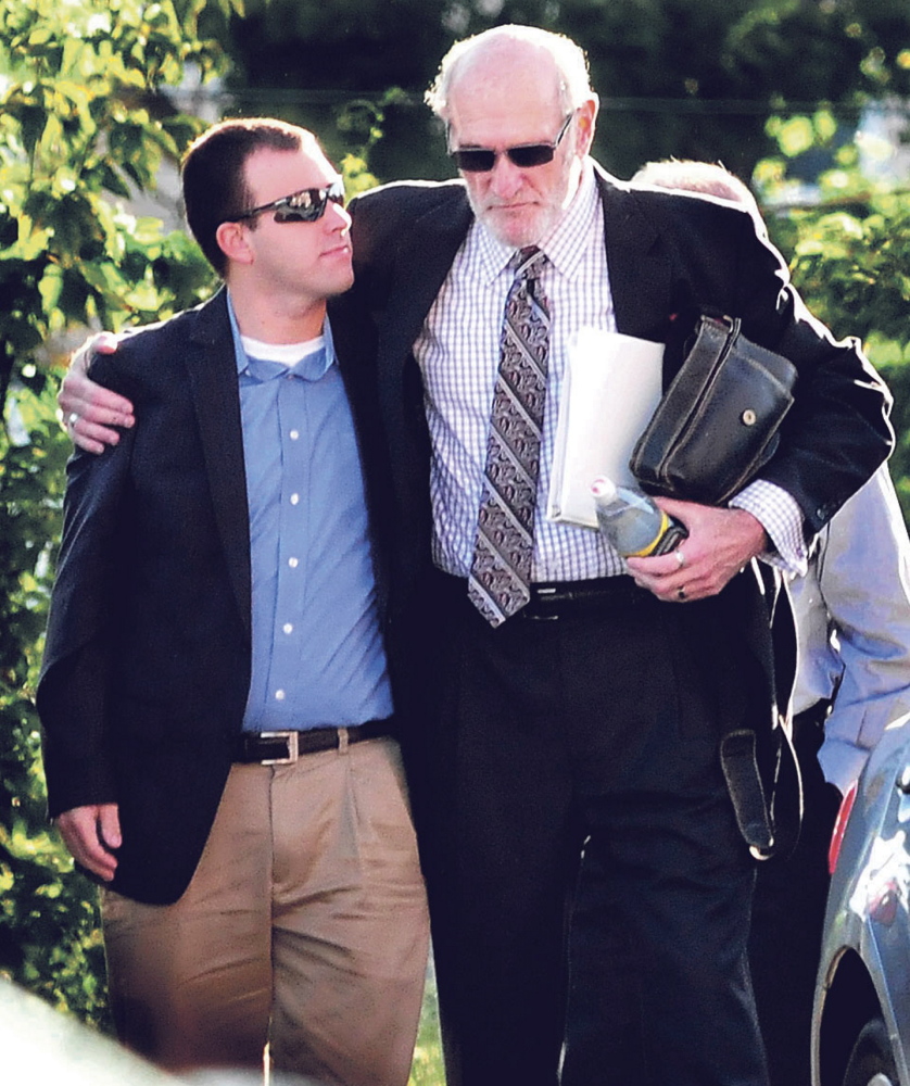 Andrew Maderios, left, is comforted by his attorney, Leonard Sharon, on Friday as they enter Somerset County Superior Court in Skowhegan for closing arguments.