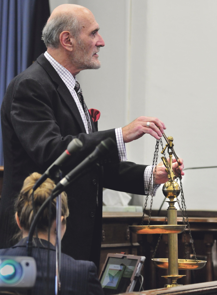 Defense attorney Leonard Sharon uses the scales of justice model in his closing arguments to the jury Friday in the Andrew Maderios trial in Somerset County Superior Court in Skowhegan.