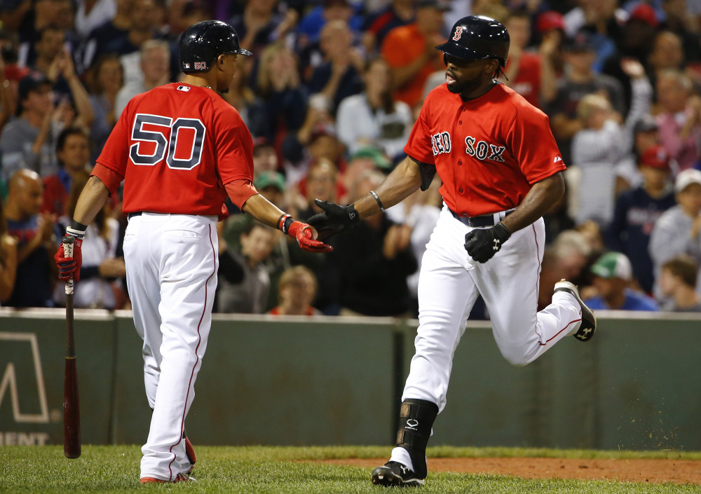 Boston’s Jackie Bradley Jr. is congratulated by teammate Mookie Betts after hitting a home run in the seventh inning of Friday night’s win over the Phillies.