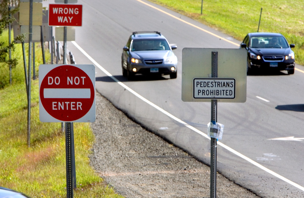 Cars drive along an off ramp on I-84 in Southbury, Conn., last week. The new signs here are larger and more reflective than the signs they replaced and they have reflective posts. “They will be as in your face as they can be,” a Department of Transportation spokesman says.