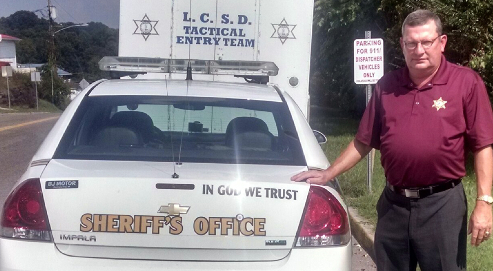 Applying “In God We Trust” decals is a way of pushing back when people feel their belief systems are being trampled on, says Gary Parsons, sheriff in Lees County, Va.