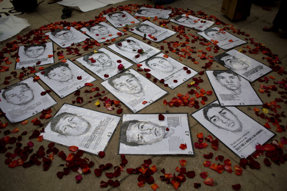 Drawings of some of the 43 missing students are surrounded by flower petals, forming the shape of a heart, during a protest marking the six-month anniversary of their disappearance, in Mexico City in March. 