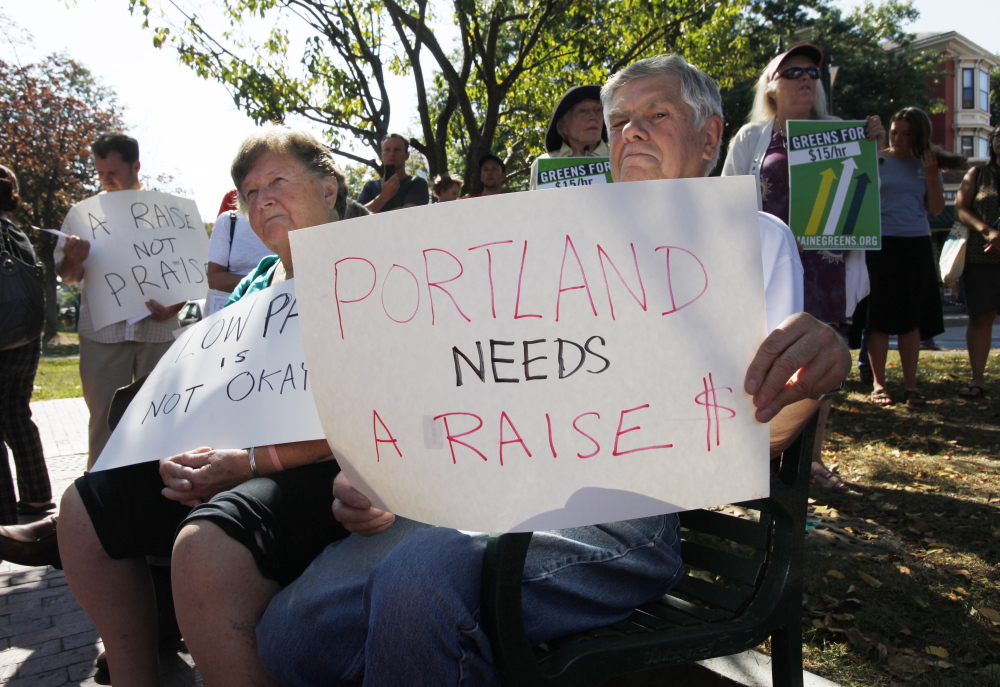 Elden McKeen, right, and his wife, Pat, left, listen to speakers at the Labor Day rally in Portland.