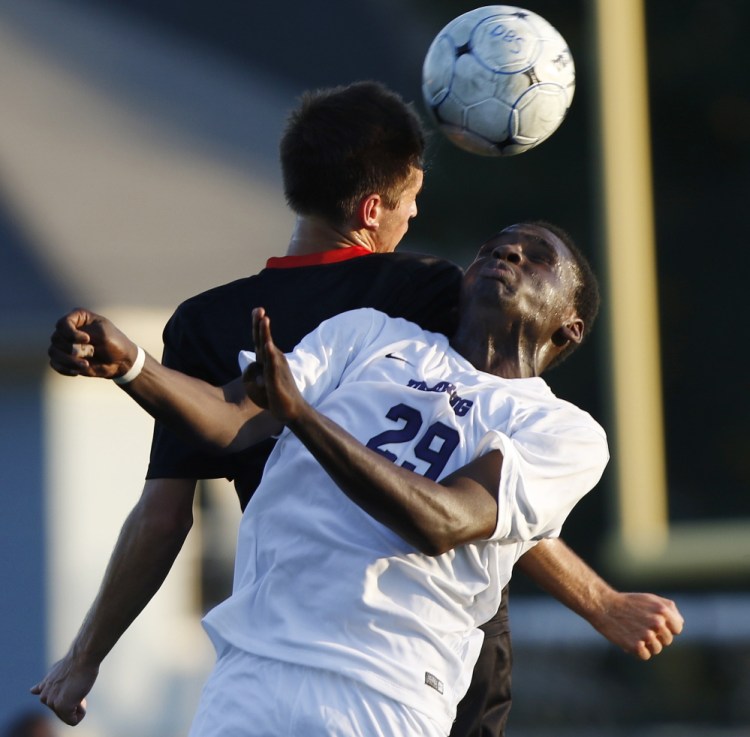 Scarborough’s Jacob McGarvey, left, and Deering’s Jonata Mbongon collide while battling for the ball during the Red Storm’s 4-0 win Monday.