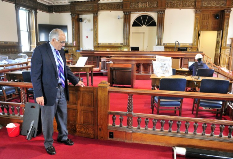 Maine Supreme Judicial Court Justice Joseph Jabar points out a new gate Thursday during a tour of the recently renovated courtroom in the old Kennebec County Courthouse in Augusta. Maine’s highest court presided there from 1830 to 1970.