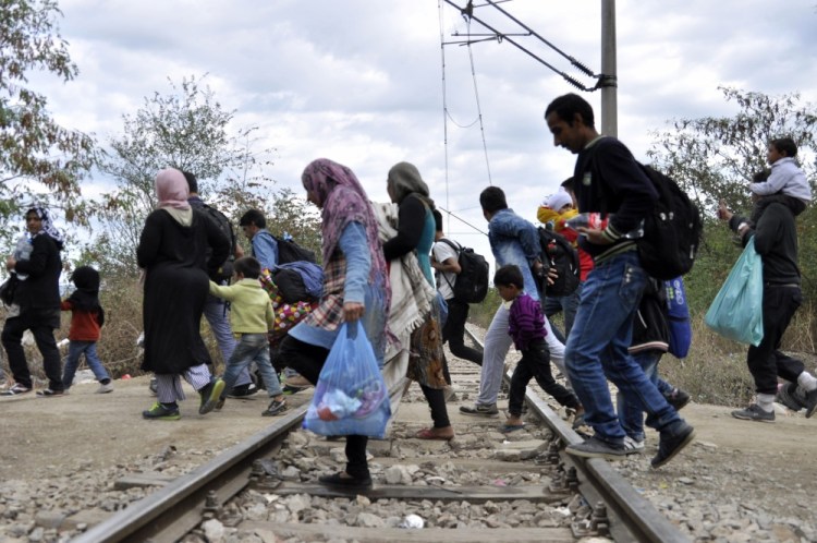 Migrants approach the southern Macedonian town of Gevgelija on Tuesday.