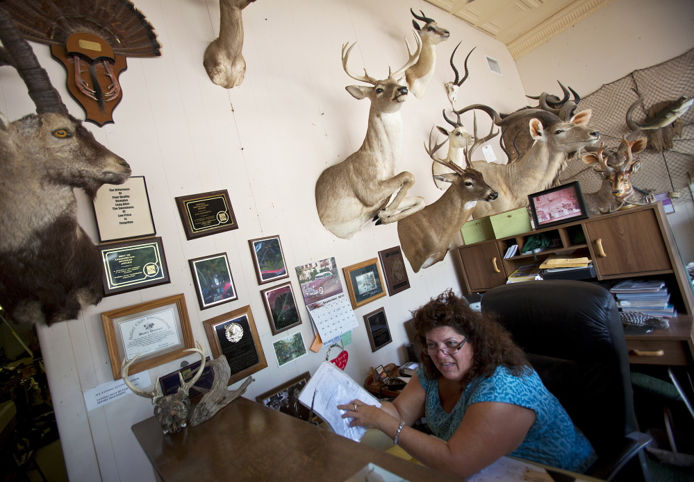 Sherri Brady, co-owner of Master Taxidermy Studio, hangs out in the lobby with some of the shop’s work in Ocoee, Fla. The shop has been in the same location for more than 40 years.