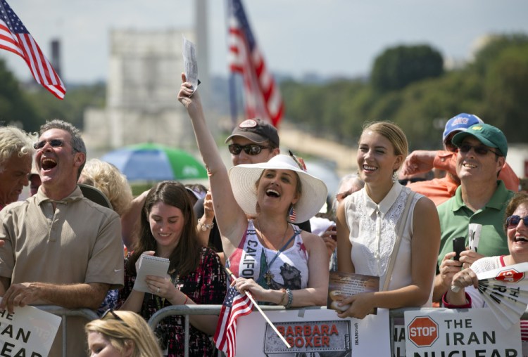 Kimberlee Crawford of Los Angeles, center, cheers as she attends a rally – led by Donald Trump and Ted Cruz – against the Iran deal Wednesday outside the Capitol in Washington. “We are led by very, very stupid people,” Trump said. “We cannot let it continue.”