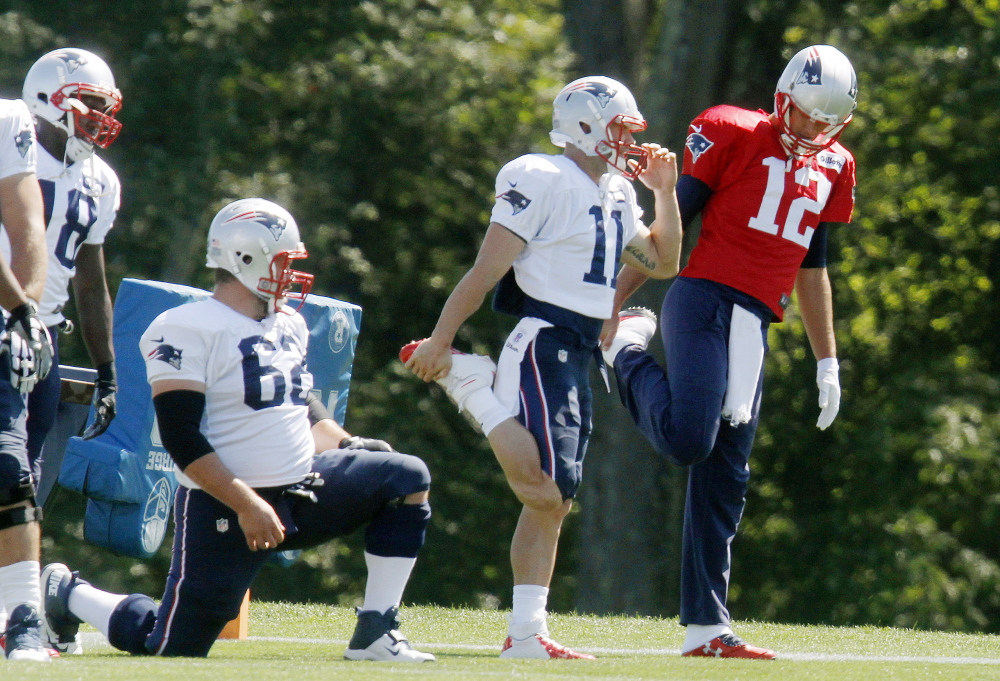 Patriots quarterback Tom Brady warms up next to wide receiver Julian Edelman (11) at the start of a recent practice. The team will begin defending last year’s championship Thursday night against the Pittsburgh Steelers after an off-season of battling cheating accusations.