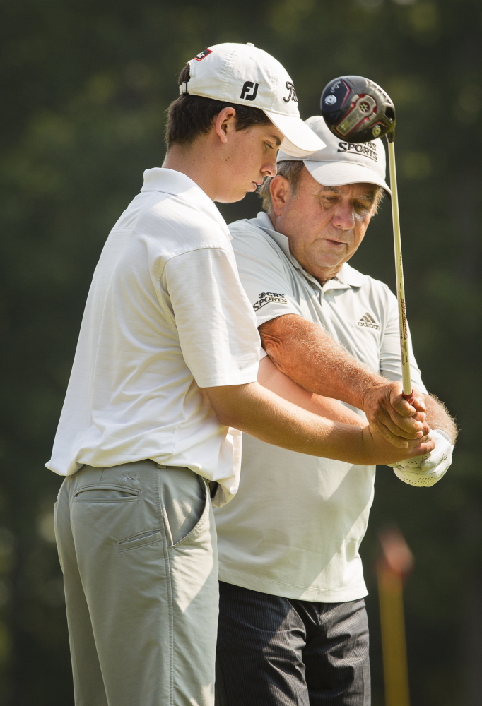 Jack Kelley of Cape Elizabeth receives instruction from Peter Kostis, a Sanford native who owns a home at the Falmouth Country Club and frequently works with the top golf professionals in the world.