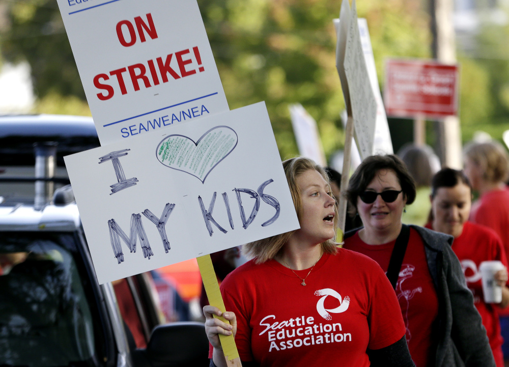 Teachers at West Seattle Elementary School begin walking a picket line Wednesday morning in Seattle after last-minute negotiations over wages and other issues failed to avert a strike in Washington state’s largest school district. 