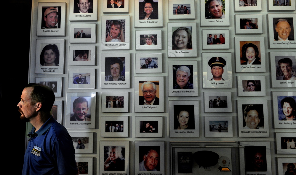 Gordon Felt, president of Families of Flight 93, stands before a wall featuring photos of those killed on Flight 93. Felt’s brother Edward was among the crash victims.
