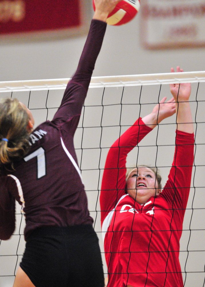 Diana Kolb of Gorham takes a shot at the net that Hannah Kibben of Cony attempts to block. Gorham improved its record to 2-1 with the victory and dropped Cony to 1-2.