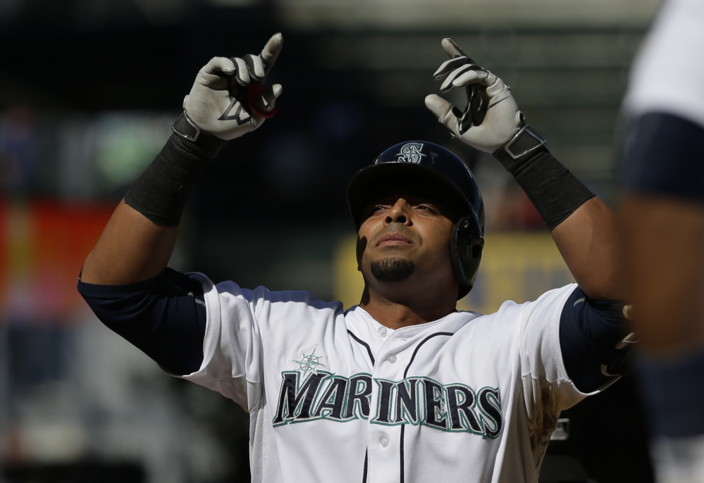 Seattle’s Nelson Cruz gestures after hitting a two-run homer in the seventh inning of the Mariners’ 5-0 victory at home over the Texas Rangers Thursday afternoon. The homer was Cruz’s 40th, matching his career high.