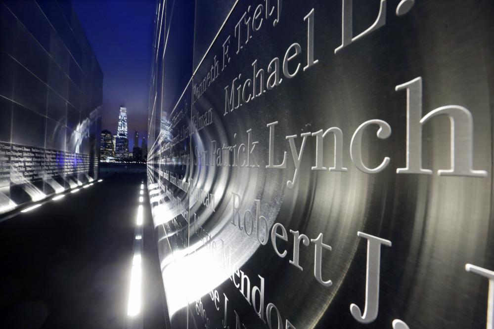 The names of New Jersey’s victims of the Sept. 11, 2001, terrorist attacks are seen on a memorial in Jersey City on Friday – the 14th anniversary of 9/11 – as 1 World Trade Center stands at center left. Close to half of the first responders and volunteers who worked at the three attack sites have developed an illness.