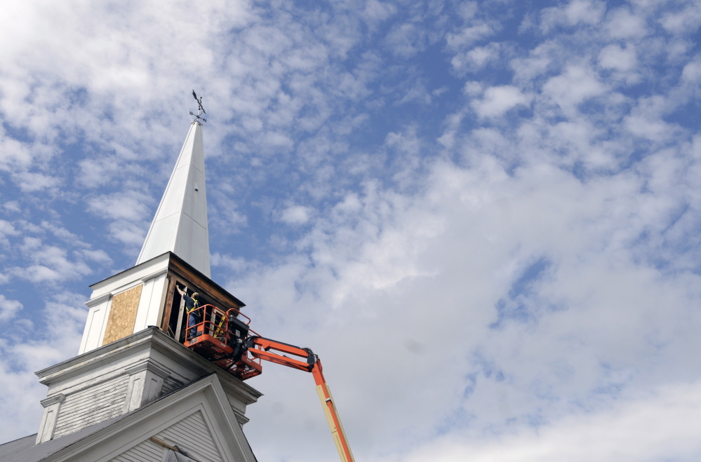 Workers frame the steeple at the North Monmouth Community Church earlier this week. Pastor Edward Spencer and the Church Council decided to borrow $28,000 to do the work. “The steeple was just so ugly compared to the rest of the church,” Spencer said.