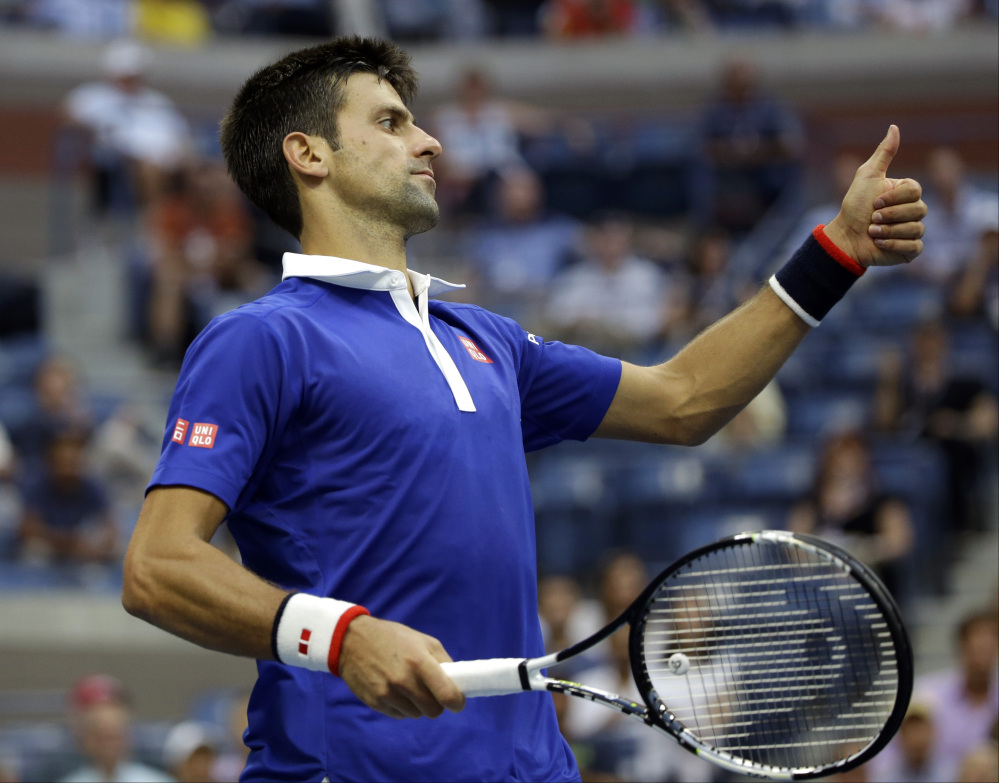 Novak Djokovic reacts after a shot from Marin Cilic during their semifinal match at the U.S. Open Friday in New York. Djokovic won 6-0, 6-1, 6-2 in 85 minutes.