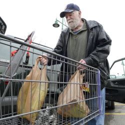 South Portland city councilors voted Wednesday to charge shoppers 5 cents for disposable bags and to impose a ban on polystyrene packaging. The city is following Portland, where similar environmental measures went into effect in April. George Burnell of Portland is shown loading plastic bags of groceries into his car at Portland’s Hannaford Back Cove store in March before the Portland stores started charging for plastic bags.