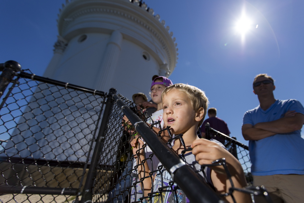 Siblings Avery, left, and Case Lappin, of South Portland, scan the waters for marine life while waiting to enter Bug Light on Saturday during Maine Open Lighthouse Day.