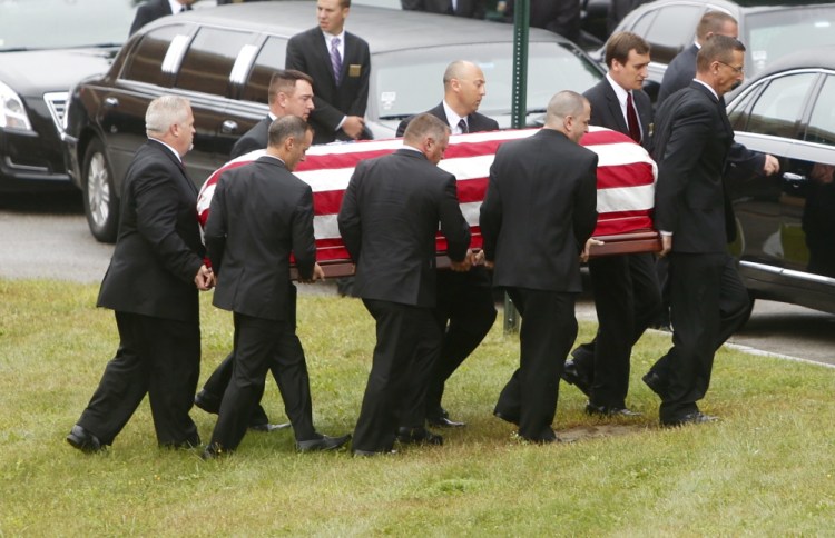 Pallbearers carry the casket of Leon Gorman from his memorial service at the Westbrook Performing Arts Center on Sunday.