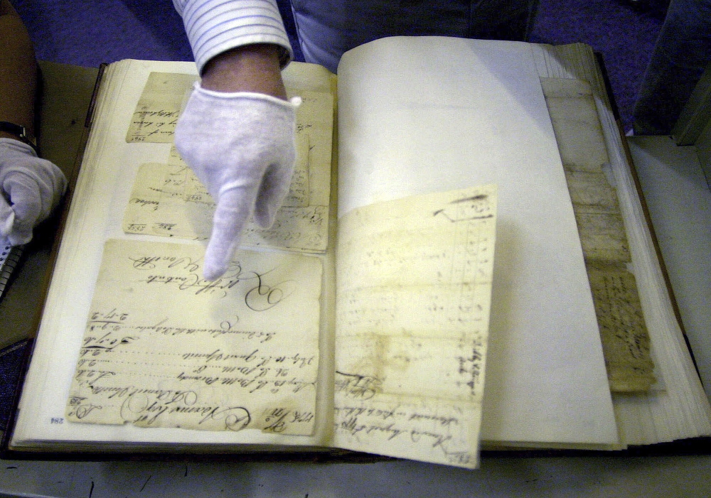 Stephen Kenney, an analyst with the Massachusetts Archives, points to one of the original writings of John Adams that are part of the collection housed in the Boston facility.