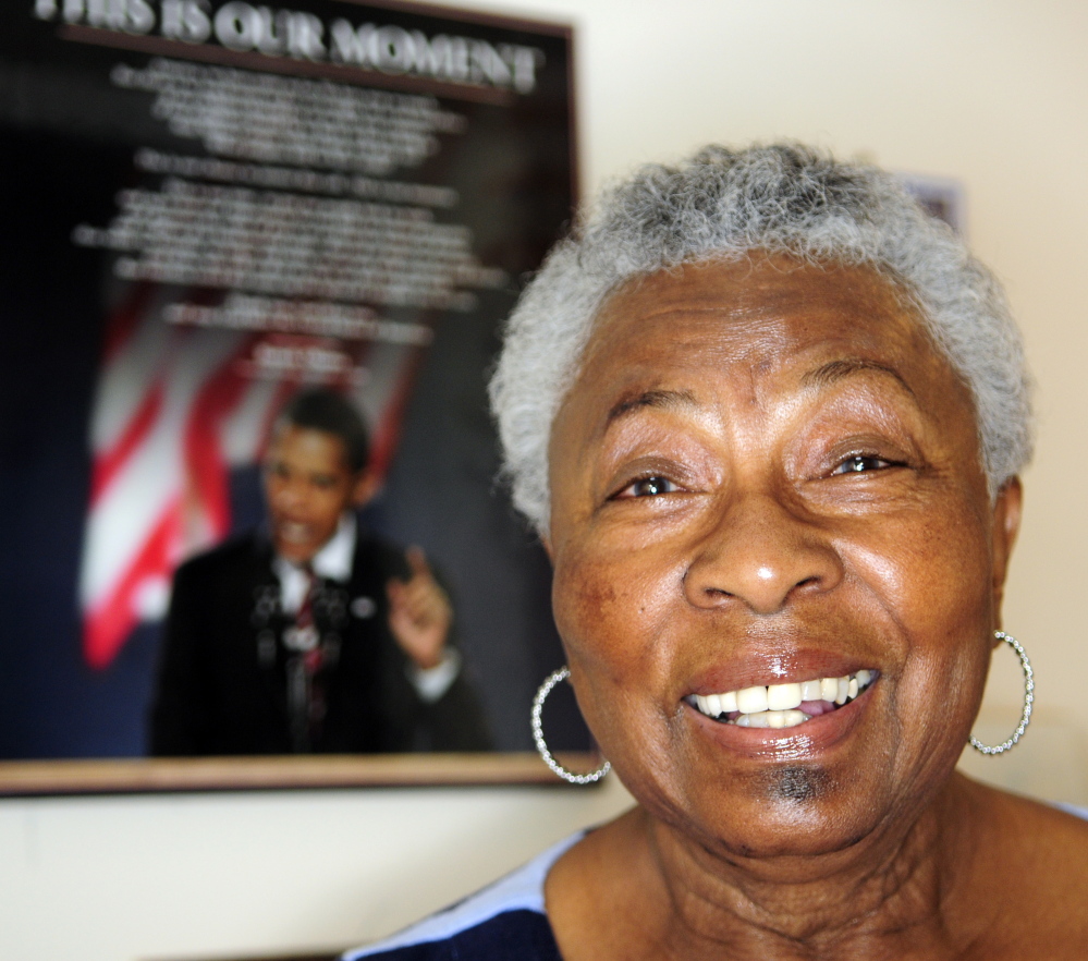 Niravelt O’Connor stands in front of a poster of President Obama recently in Augusta.