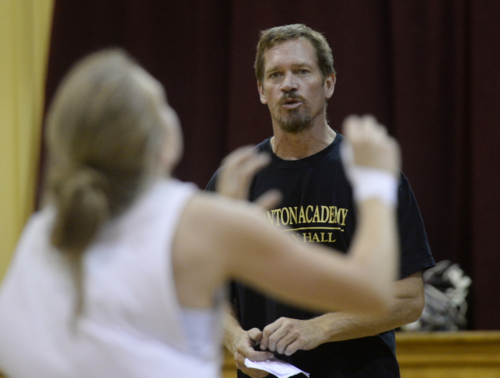 Volleyball coach Keith O'Leary talks with players as they run drills during practice at Thornton Academy. Shawn Patrick Ouellette/Staff Photographer