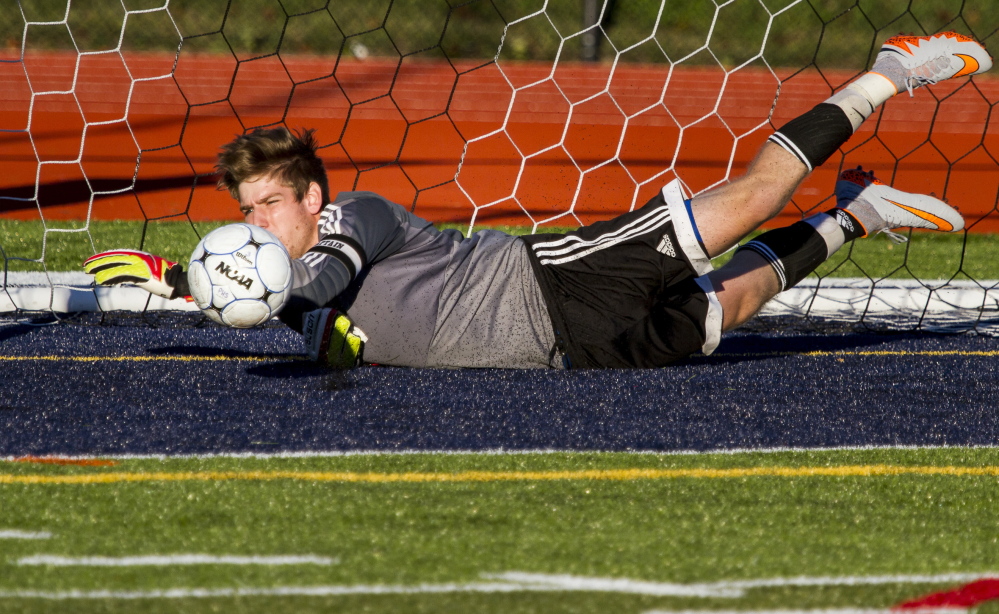 Thornton Academy goalkeeper Andrew Coleman, a senior, dives for one of eight saves Tuesday against Portland at Fitzpatrick Stadium. The teams played to a 0-0 tie.