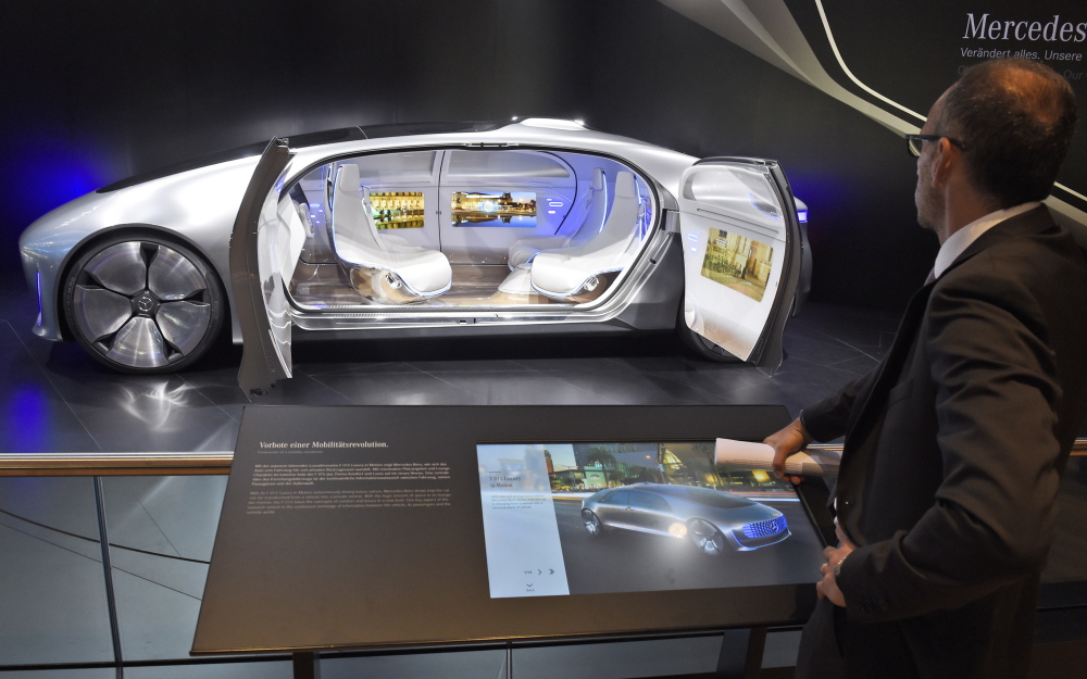 A visitor looks at the ‘F 015 Luxury in Motion’ autonomous driving vehicle at the Mercedes stand Tuesday, the first press day of the Frankfurt Auto Show IAA in Frankfurt, Germany. The car show runs through Sept. 27. 