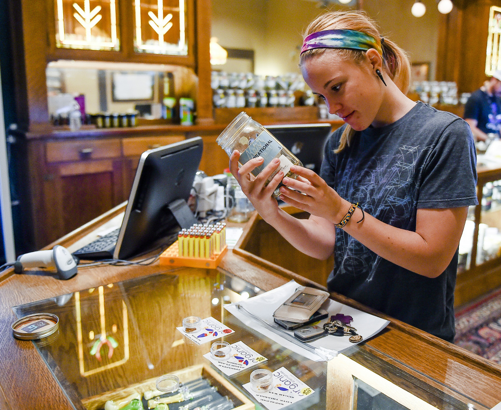 Shelby Johnson checks out products at Organic Alternatives during Colorado’s marijuana tax holiday in Fort Collins, Colo.