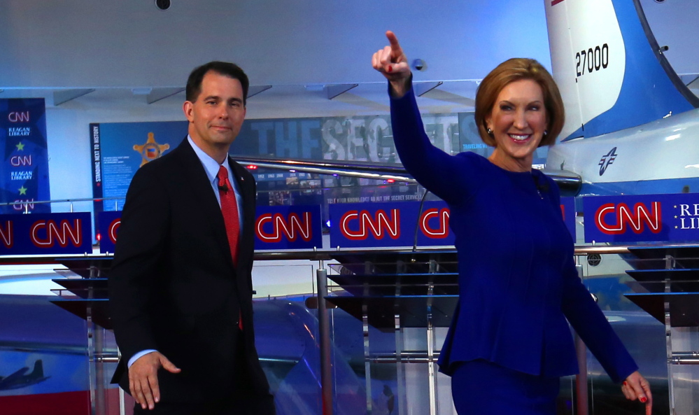 Republican presidential candidates Scott Walker, left, and Carly Fiorina take the stage at the Reagan Library in Simi Valley, Calif., on Wednesday. The debate’s tone signaled that the campaign is moving into a more serious phase.