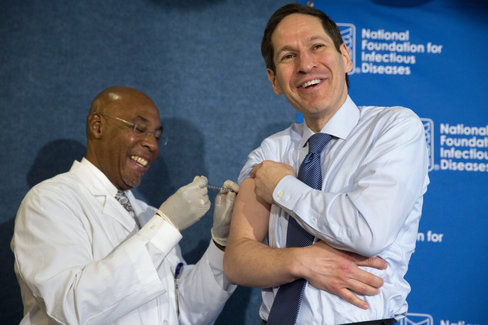 Centers for Disease Control and Prevention Director Dr. Tom Frieden receives a flu shot from nurse B.K. Morris last year at the National Press Club in Washington.
