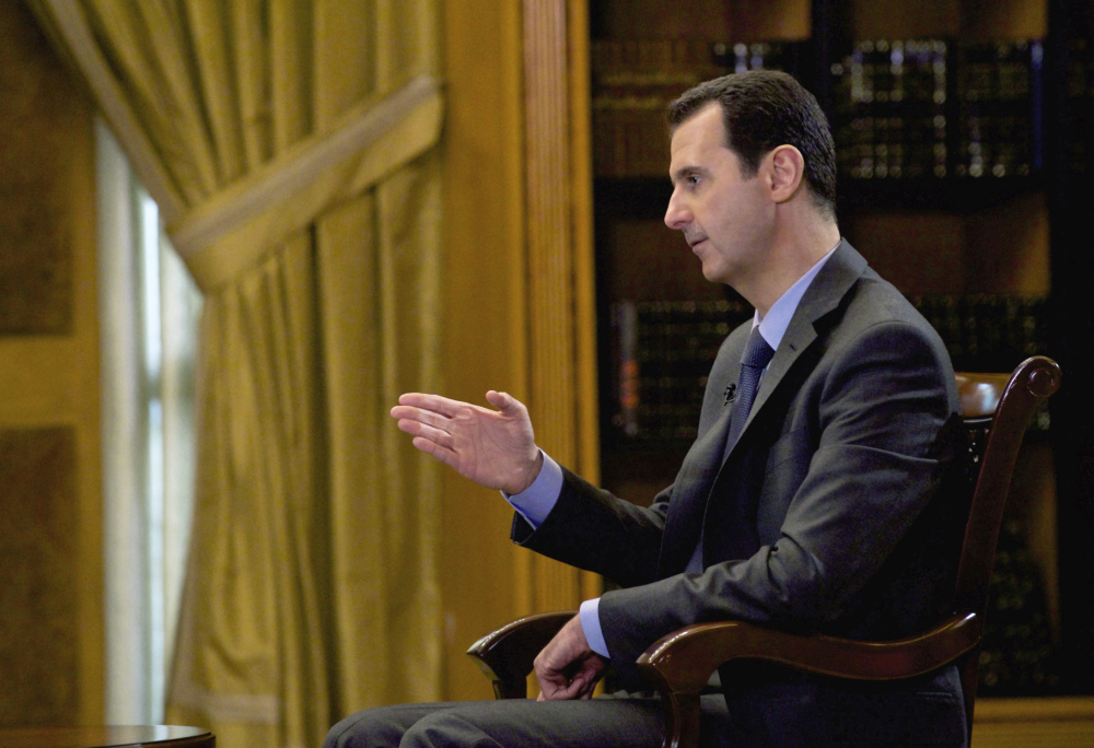 FILE - In this file photo released Wednesday, March 4, 2015, by the Syrian official news agency SANA, Syrian President Bashar Assad speaks during an interview with Portuguese state television, RTP, in Damascus, Syria. Speaking in an interview with Russian media, Tuesday, Sept. 15, 2015, Assad said the refugee crisis now hitting Europe is a direct result of the West’s support of “terrorists” in Syria. The Russian president has said it is impossible to defeat the Islamic State group without cooperating with Damascus, and in recent days has sent about a half-dozen battle tanks and other weaponry to Syria. (AP Photo/SANA, File)