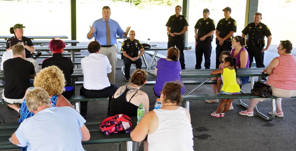 Augusta police Lt. Christopher Massey, center, talks about efforts to reduce crime during a public meeting Thursday at the base of Sand Hill in Augusta.