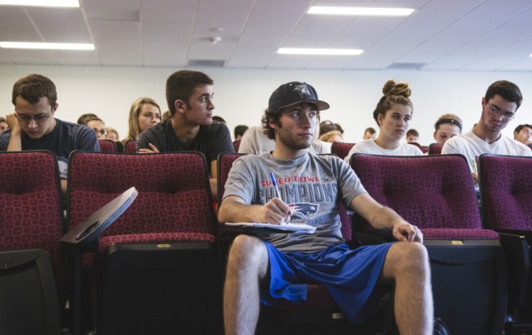 Senior Chris Carrigan and others listen to professor Michael McCann during a Deflategate class at UNH on Wednesday. “You see the title, ‘Deflategate,’ and you say, ‘How is that useful?’ McCann said. “Learning what labor law is, learning what antitrust law is ... is very useful.”