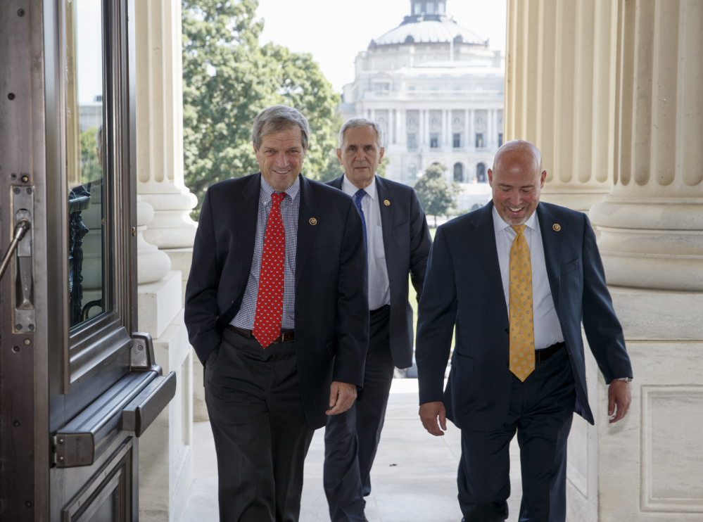 From left, Rep. Mark DeSaulnier D-Calif., Rep. Lloyd Doggett, D-Texas and Rep. Tom MacArthur R-N.J., arrive for a vote on Capitol Hill in Washington on Friday to block Planned Parenthood’s federal funds for a year.