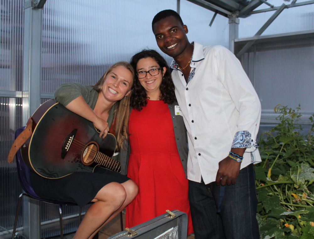 Caroline Cotter, left, Elizabeth Reardon and resident gardener Chomba Kaluba at the 409 Cumberland harvest party for the gardens and greenhouse on the Portland apartment building’s roof.