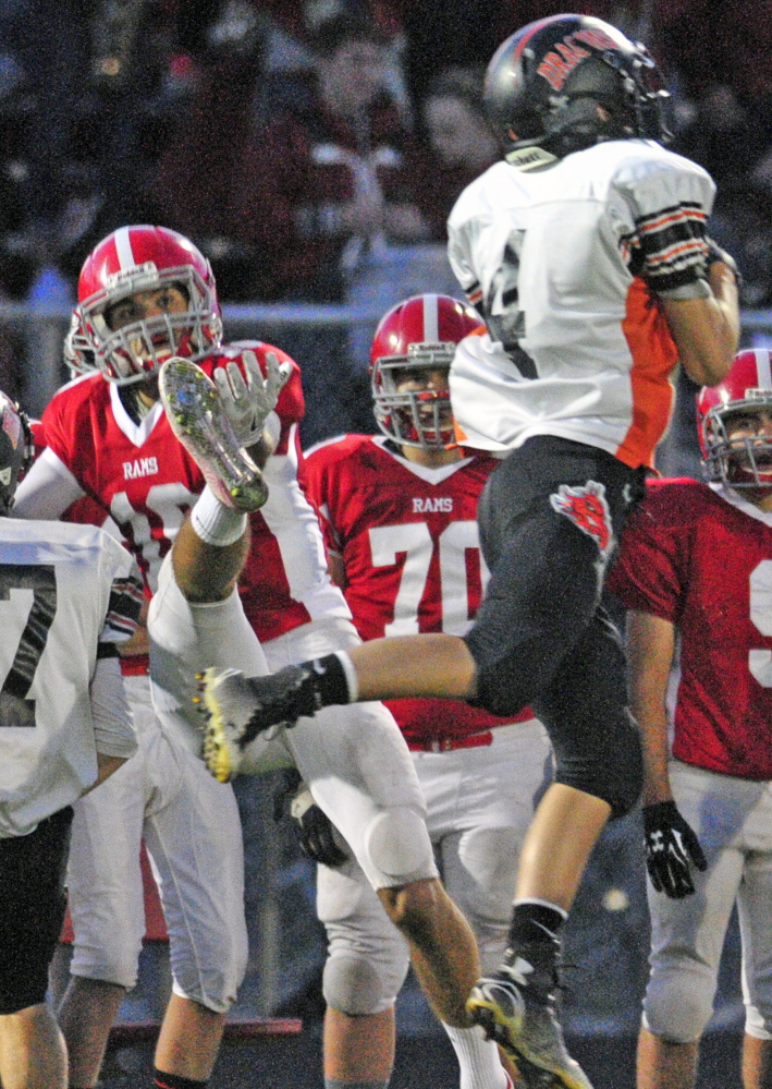 Brunswick’s Aaron Carlton, right, intercepts a pass intended for Cony’s Anthony Brunelle to set up the first touchdown Friday in Brunswick’s 58-27 win.