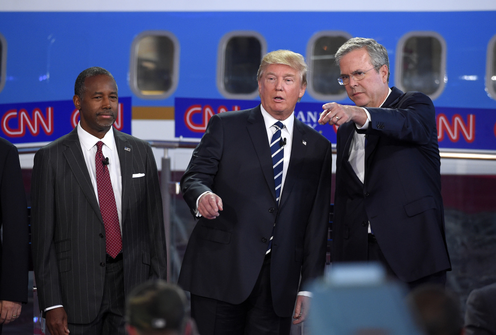 Republican presidential candidates, from left, Ben Carson, Donald Trump and former Florida Gov. Jeb Bush chat during the CNN Republican presidential debate at Wednesday. Trump’s rivals emerged from the second Republican debate newly confident that the brash billionaire will fade if the primary takes a more substantive turn.